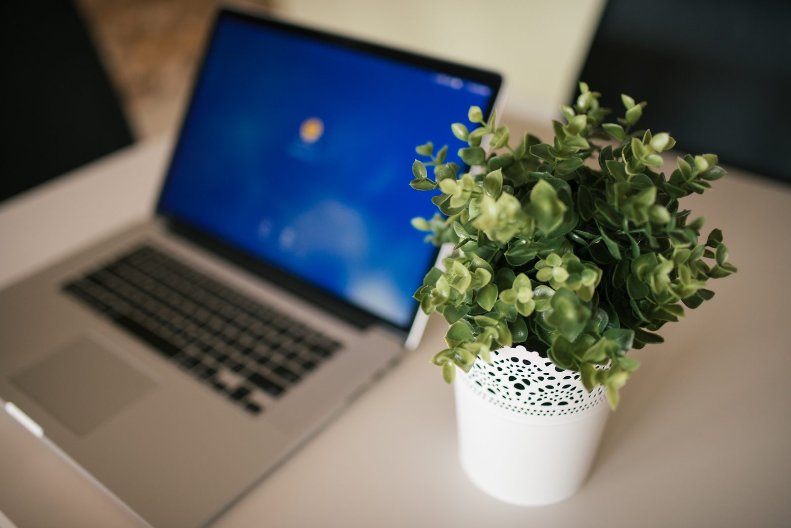 A laptop on a desk in a bright modern workspace