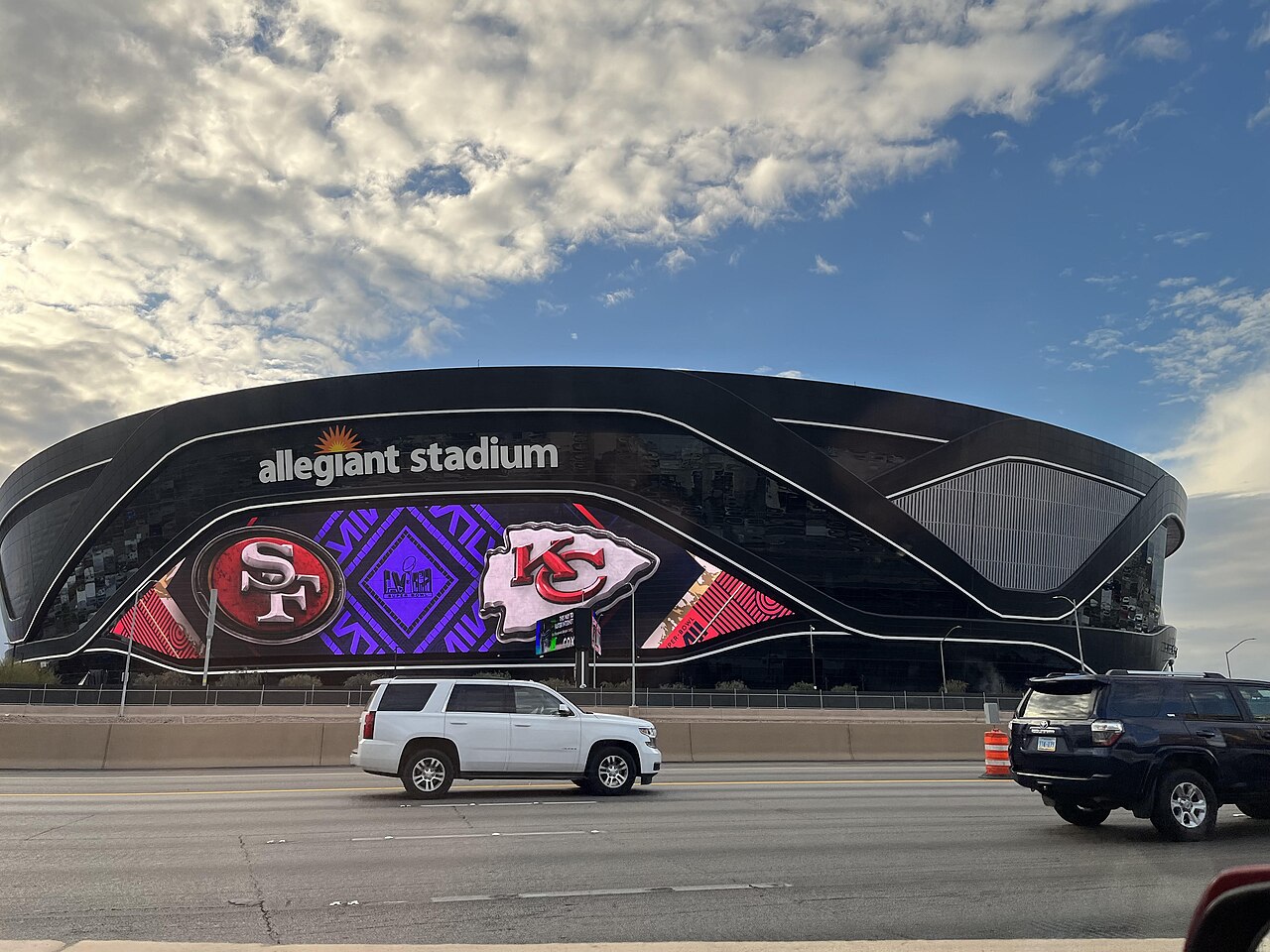 Allegiant Stadium seen from Interstate 15, its black glass exterior unmistakable on the Las Vegas skyline