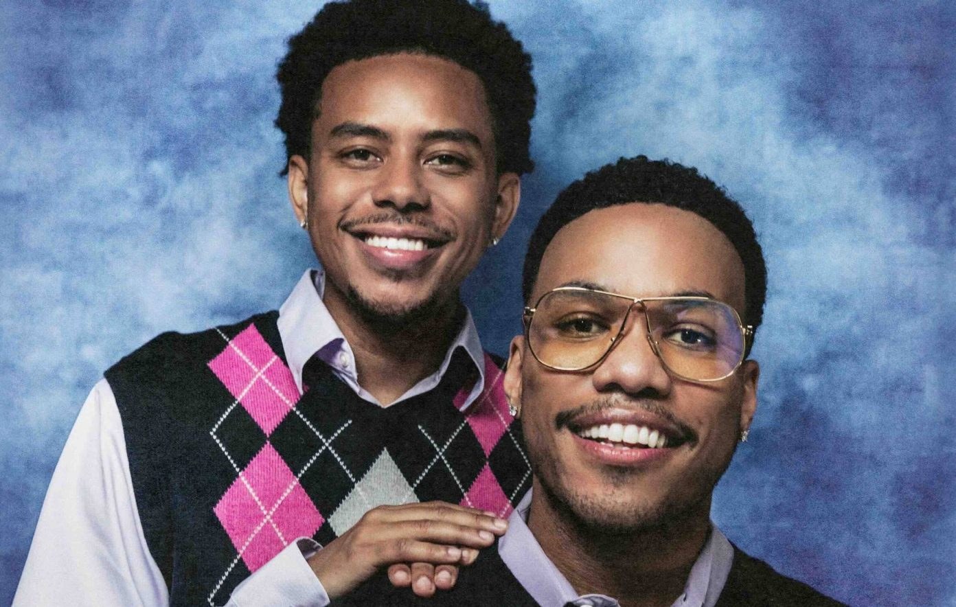 Anderson .Paak and Cordae posing together in a studio portrait.