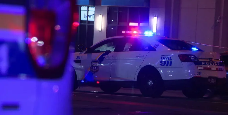 Philadelphia police cruisers on a city street at night