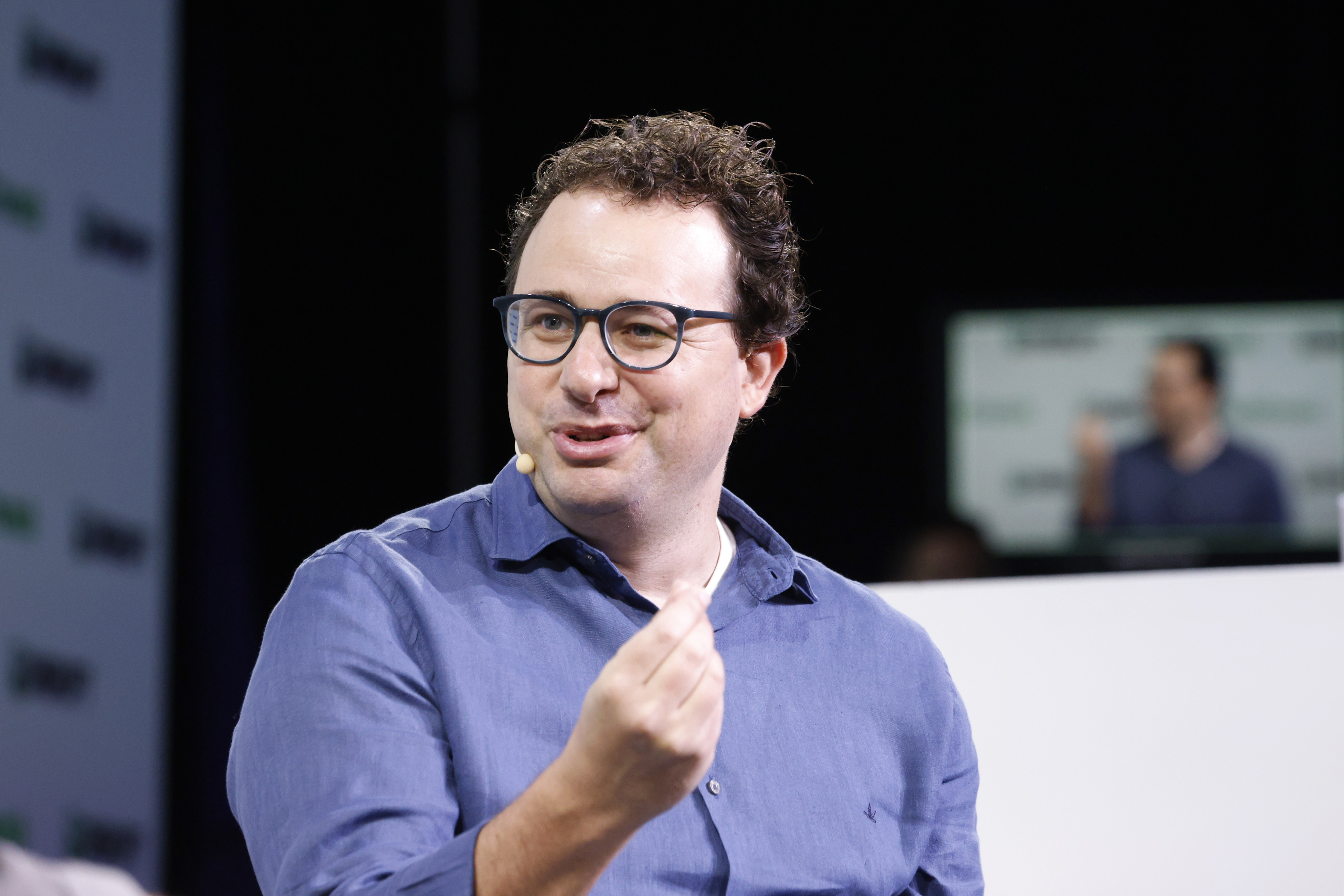 Anthropic CEO Dario Amodei speaking on stage at TechCrunch Disrupt 2023