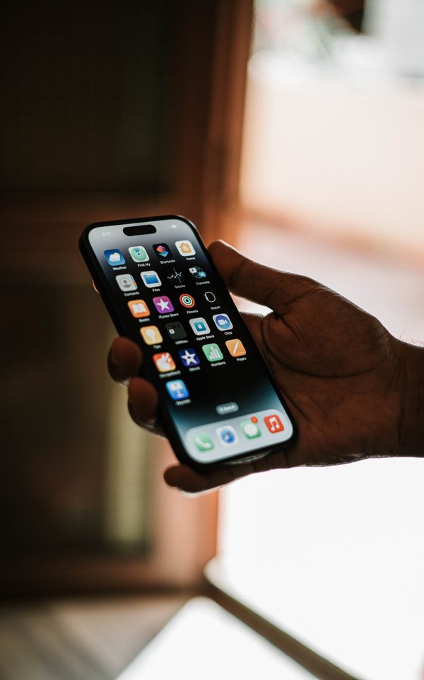 An iPhone with the iOS software update screen on a bright background
