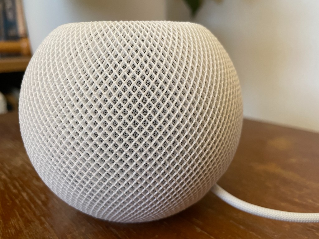 A HomePod mini smart speaker on a table