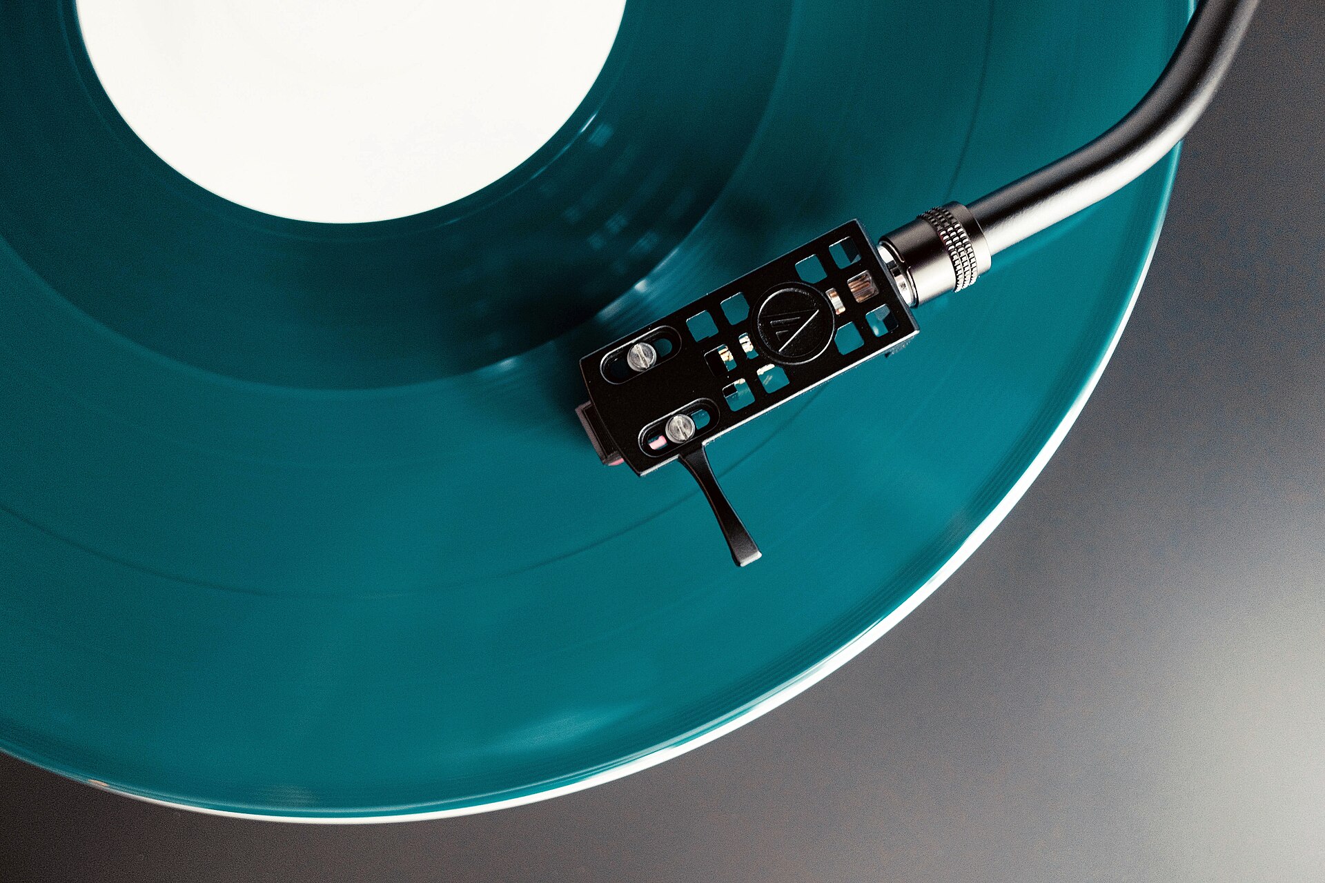 A turntable playing a coloured vinyl record