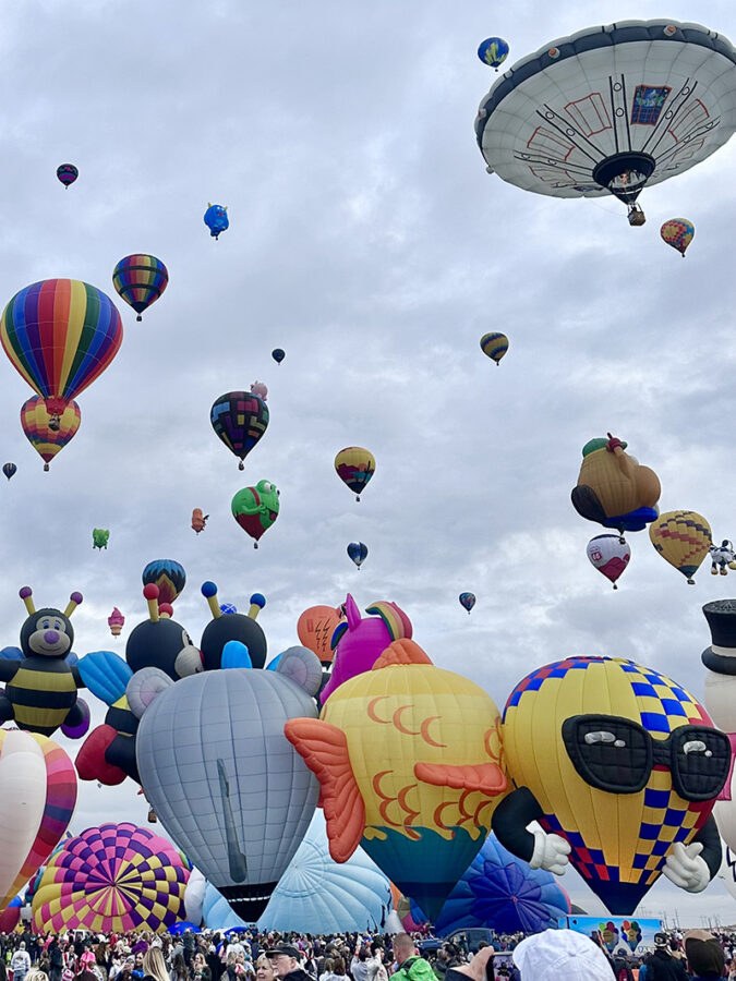 Special-shape balloons including an elephant, a penguin and a clown rise over the launch field