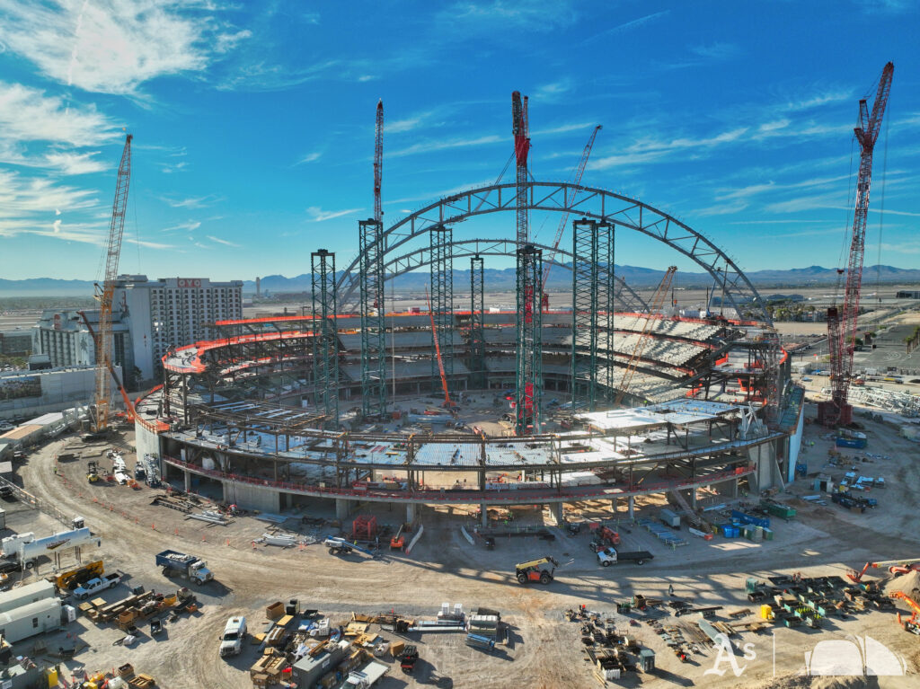 Steel truss arches rising over the Athletics’ Las Vegas ballpark construction site — the A’s ballpark opens in 2028, but Bally’s casino towers come later