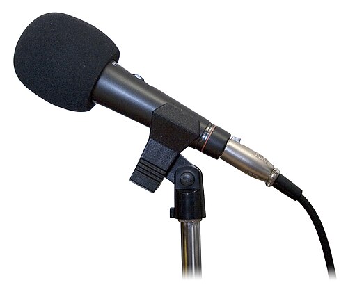 A studio microphone — TBOY's creator-led business news reaches more than 150 million lifetime downloads.