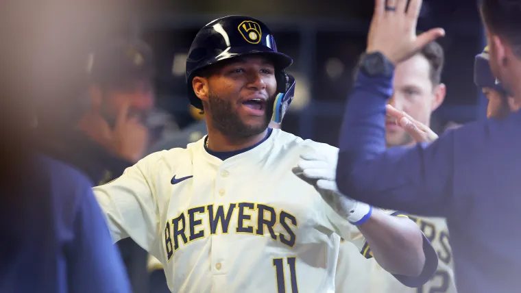 Jackson Chourio (11) gets high-fives in the Brewers dugout after coming through in a big October spot.