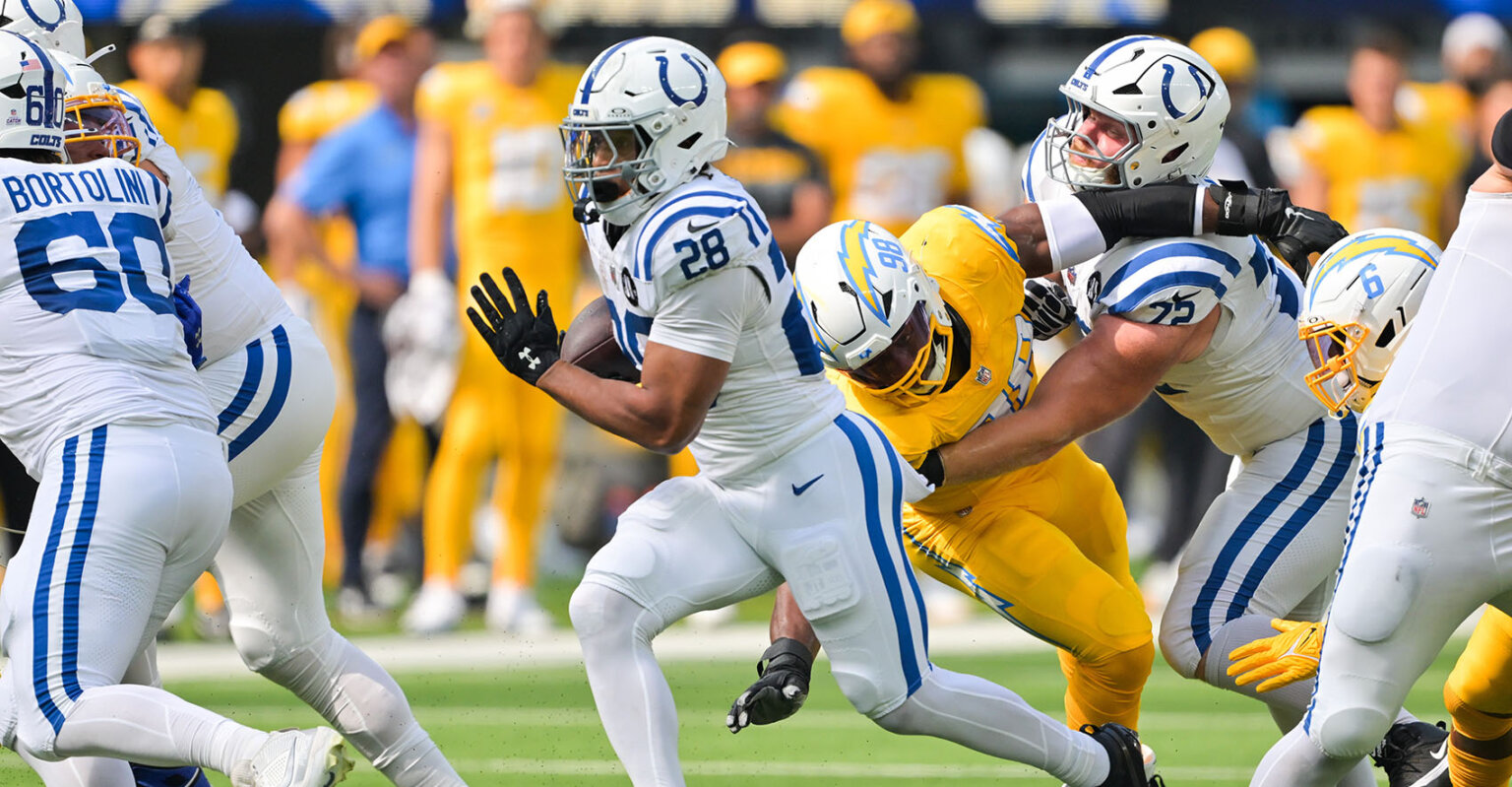 Indianapolis Colts running back Jonathan Taylor (28) carries the ball in the white away uniform.