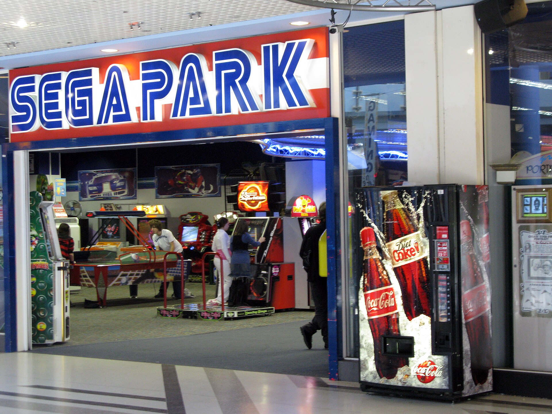 A bright modern arcade floor with Sega cabinets