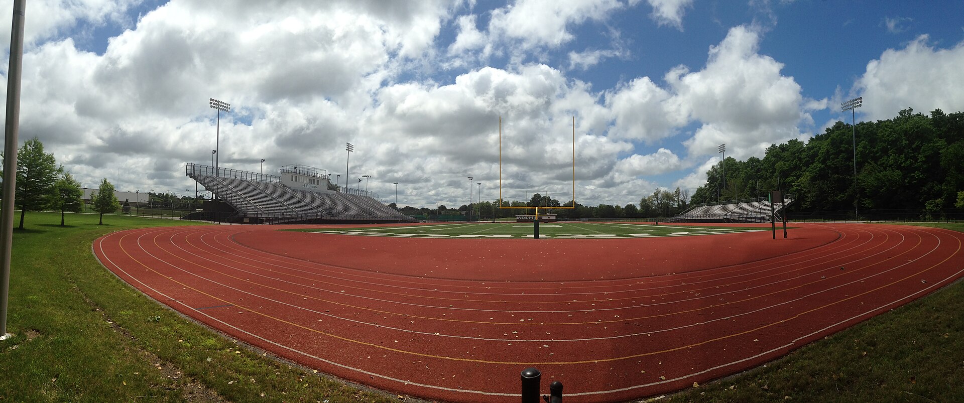 A high school football stadium under the lights on game night