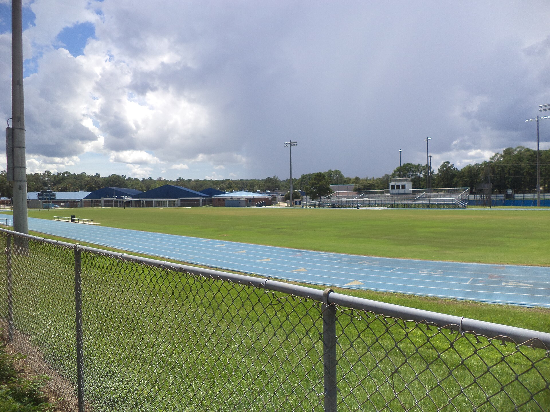 A high school football field and running track on a school campus