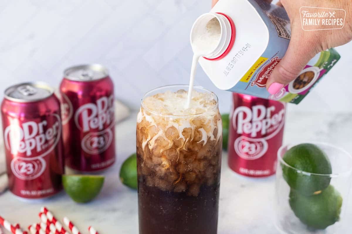 A finished dirty Dr Pepper with cream swirled through the soda