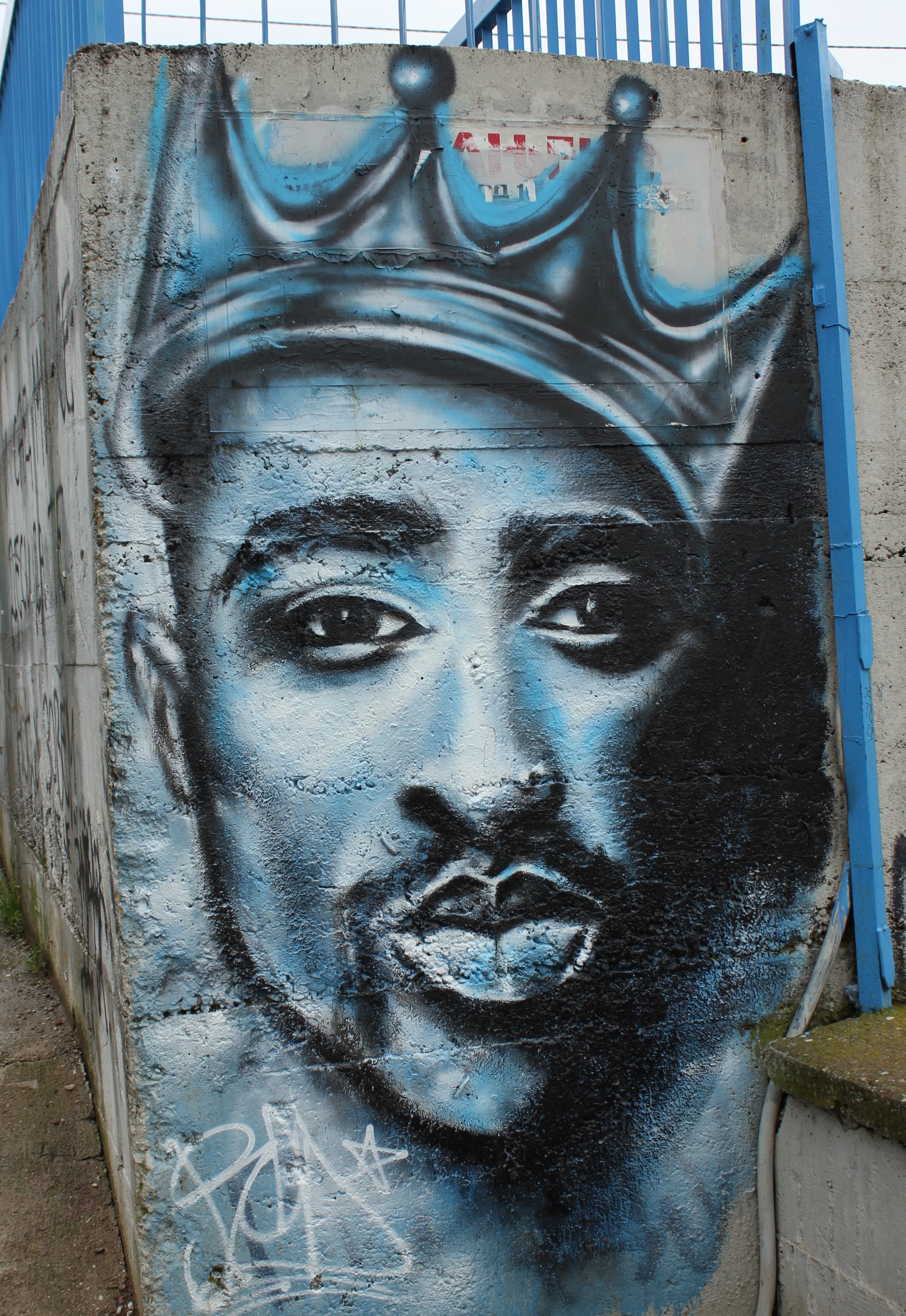 A colorful mural of Tupac Shakur
