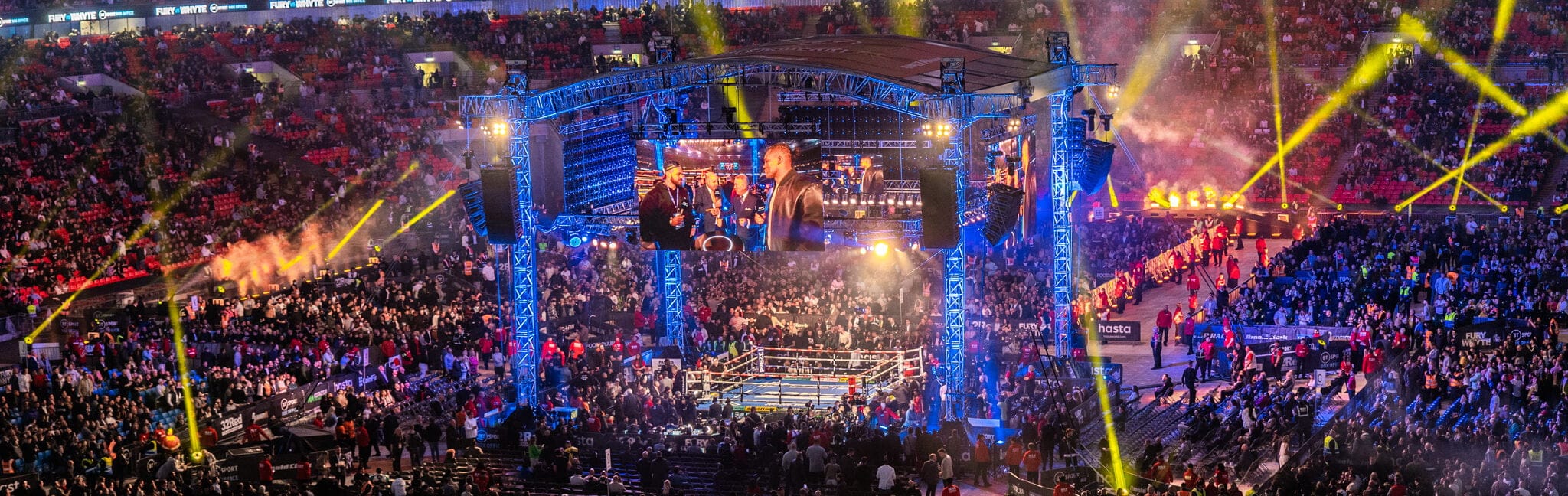 A sold-out fight-night arena under the lights