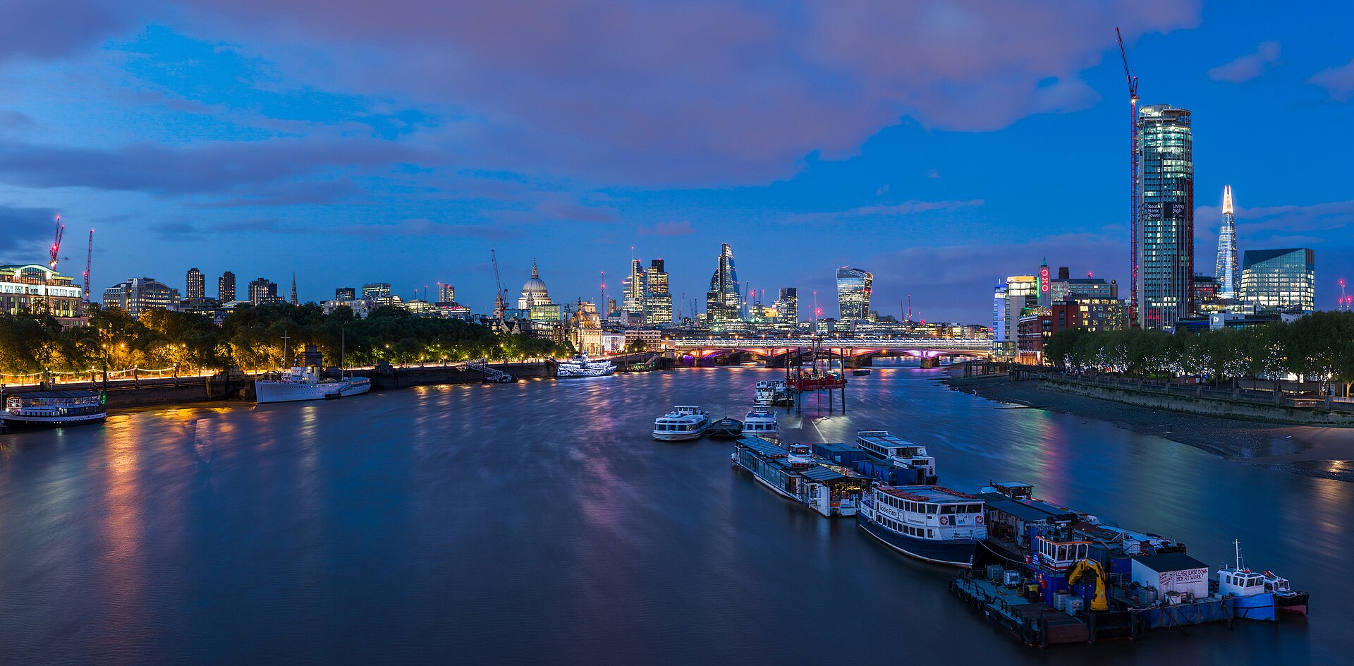 The City of London skyline along the River Thames on a bright day