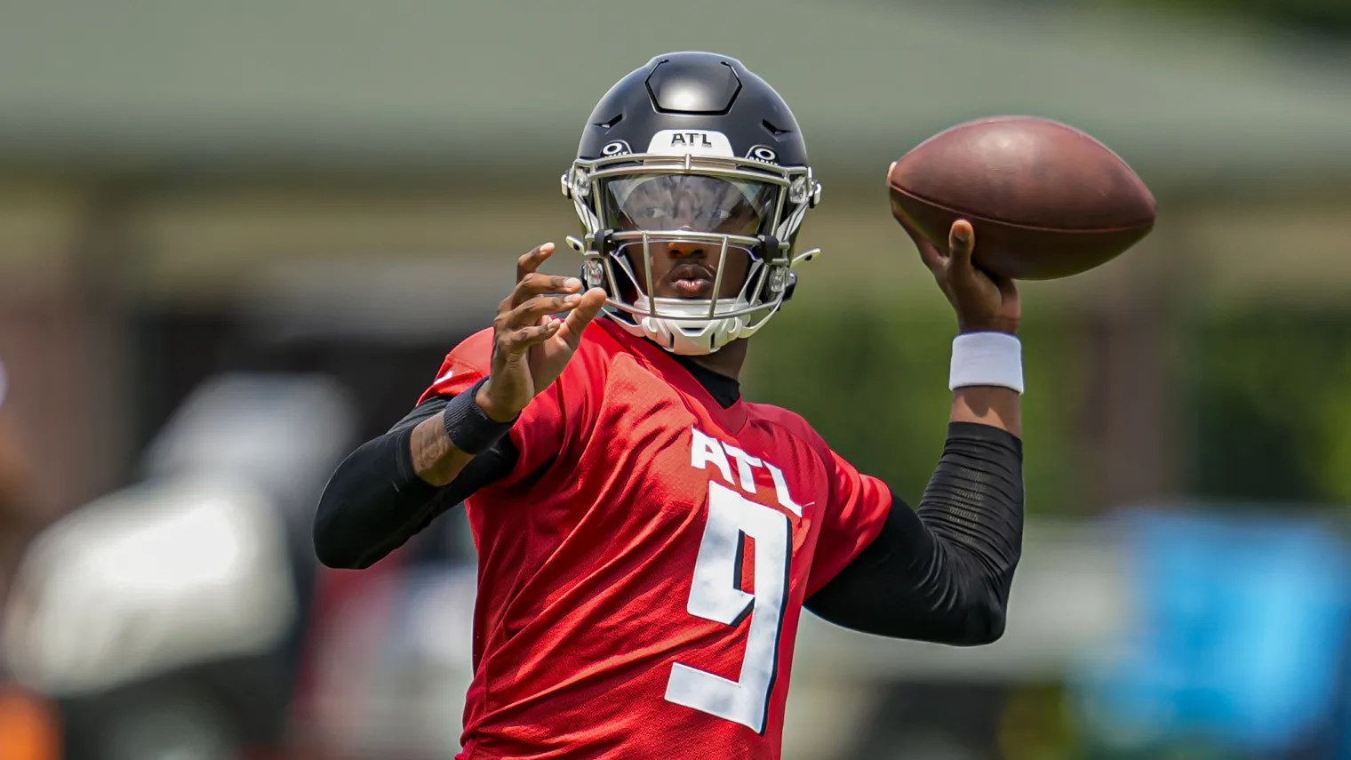 Atlanta Falcons quarterback Michael Penix Jr. throwing in a red practice jersey.