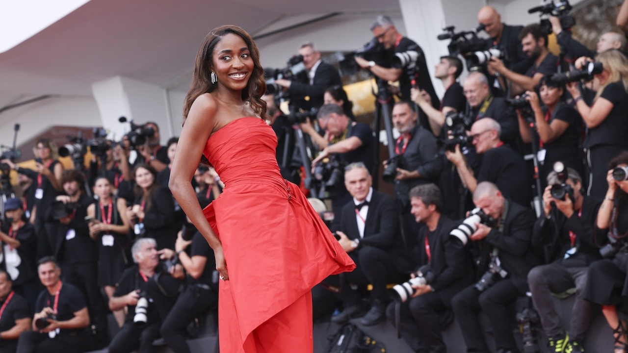 A star poses for photographers on the Venice Film Festival red carpet
