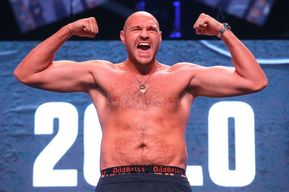 Tyson Fury flexing at a weigh-in