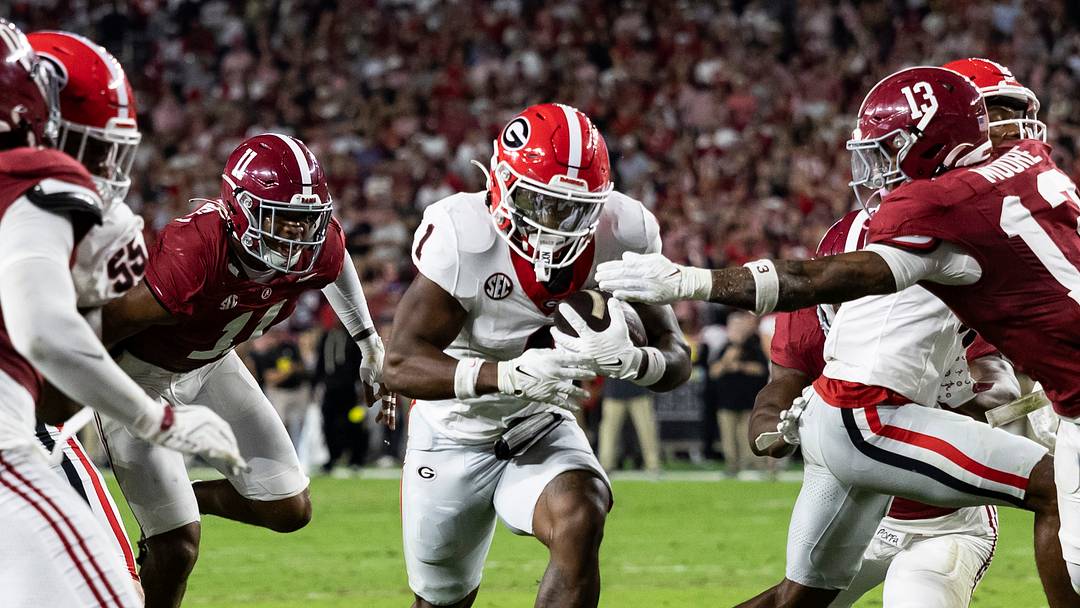 Georgia ball carrier wrapped up by Alabama defenders — No. 2 Georgia visits No. 6 Alabama on Saturday night at Bryant-Denny Stadium.