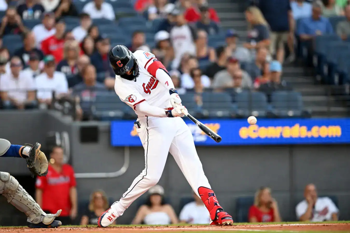 José Ramírez swings for the Cleveland Guardians in his home whites