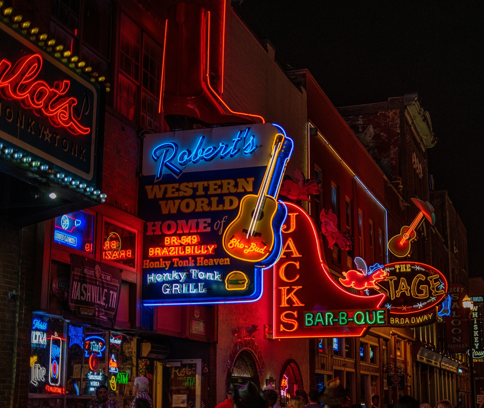 Neon honky-tonk signs on Broadway in Nashville at night, the world Heartland's story moves through