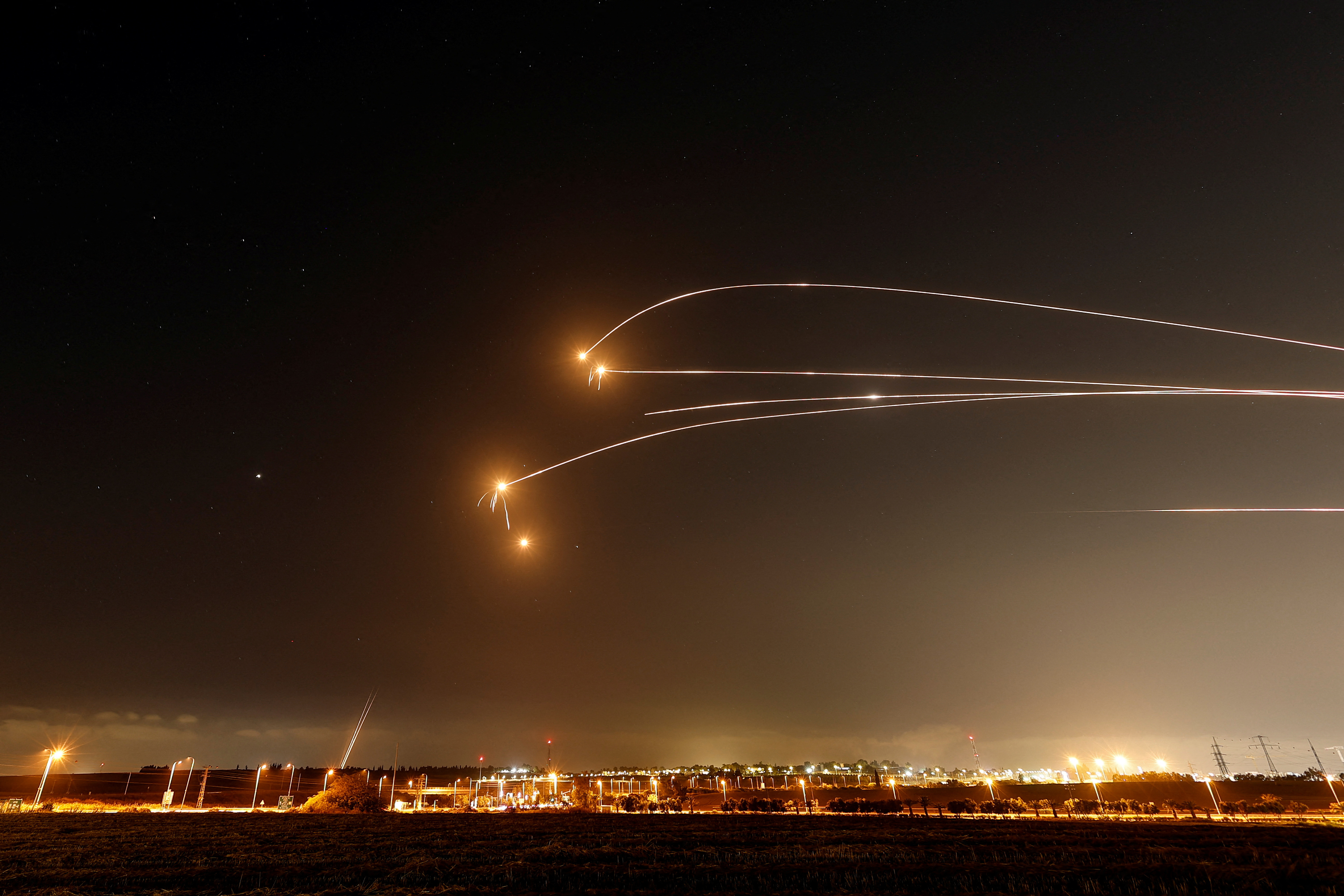 Missiles arc across the sky during a regional exchange โ file photo