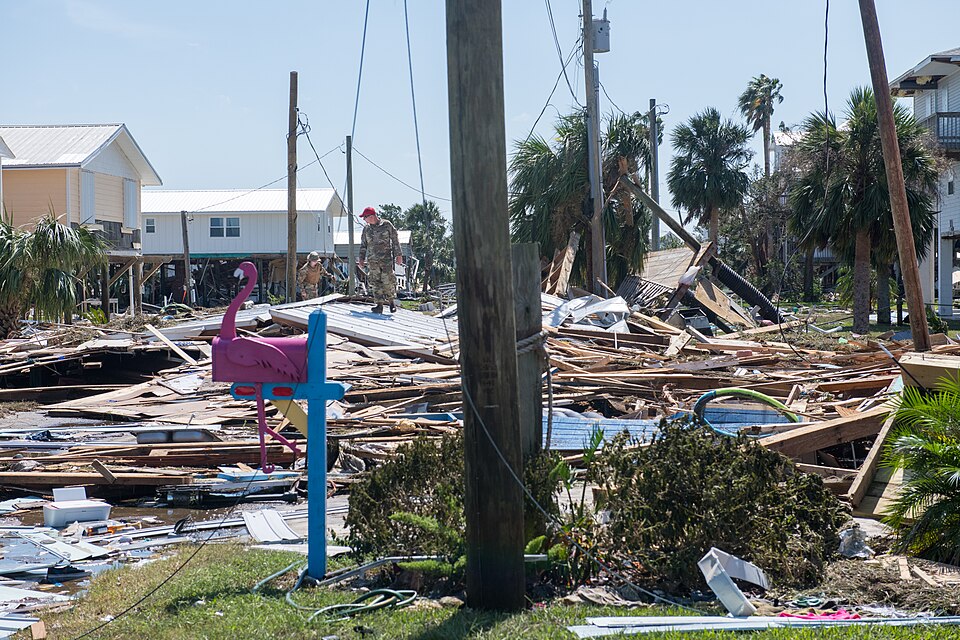 Recovery crews assess damage in daylight after a hurricane