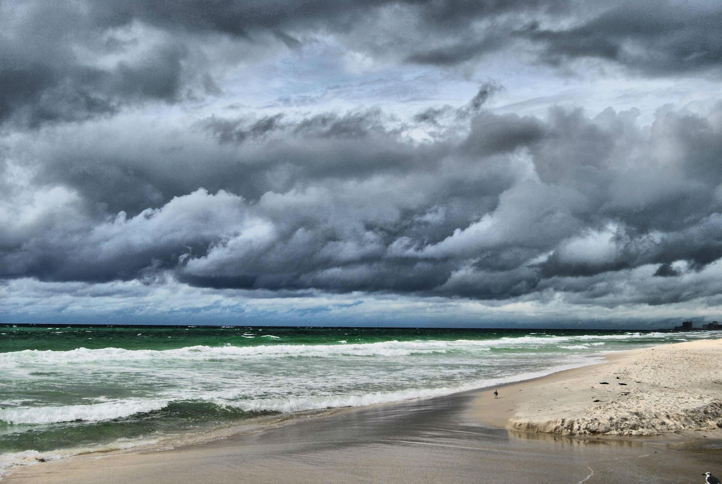 Dark storm clouds gathering over a Gulf Coast beach ahead of Hurricane Isaias