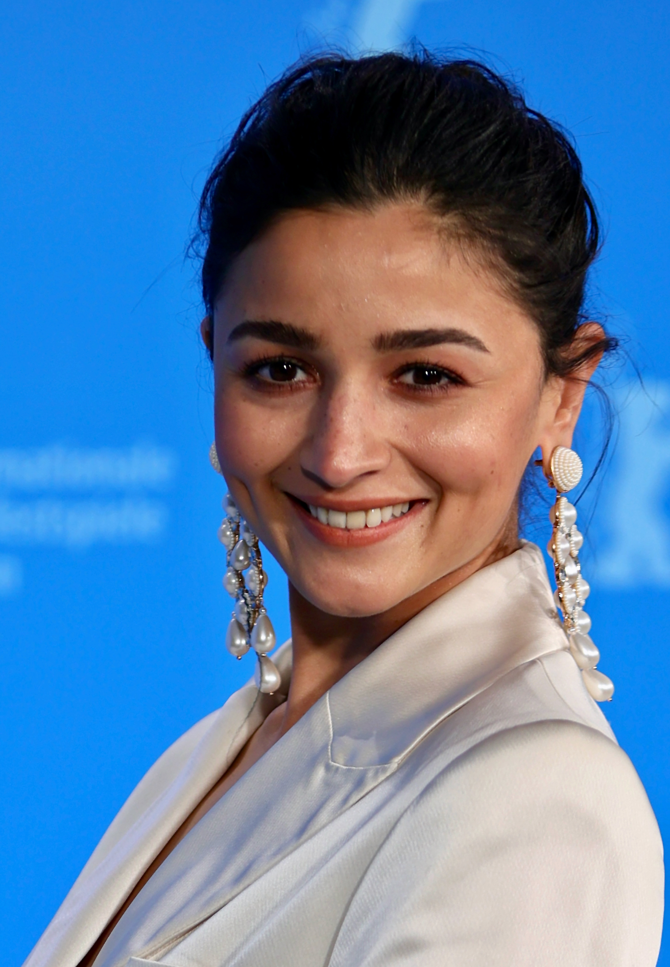 Alia Bhatt smiling on the red carpet at the 2022 Berlin International Film Festival, where her film Gangubai Kathiawadi premiered.