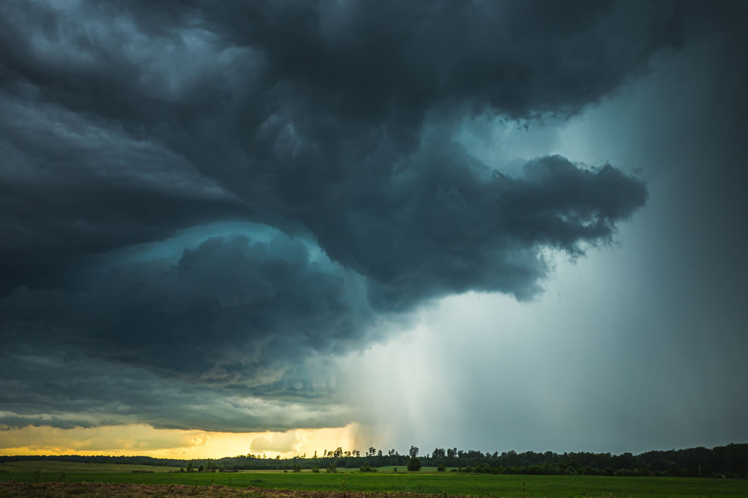 Dark, churning storm clouds gather over the horizon as a tropical system approaches