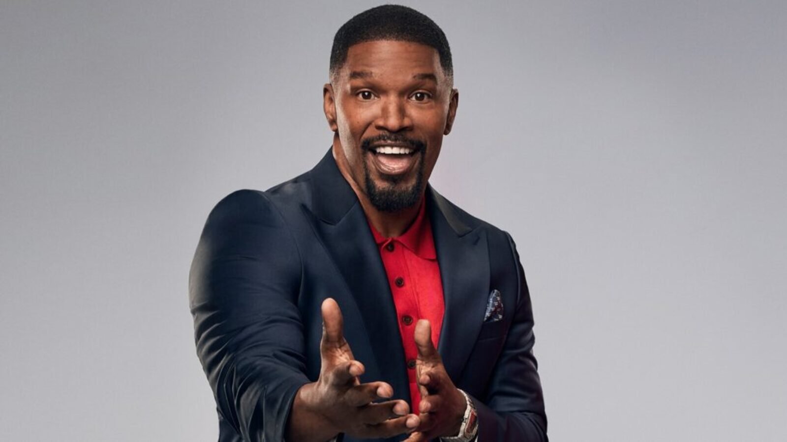 Jamie Foxx smiling in a suit in a Fox promotional photo for Beat Shazam
