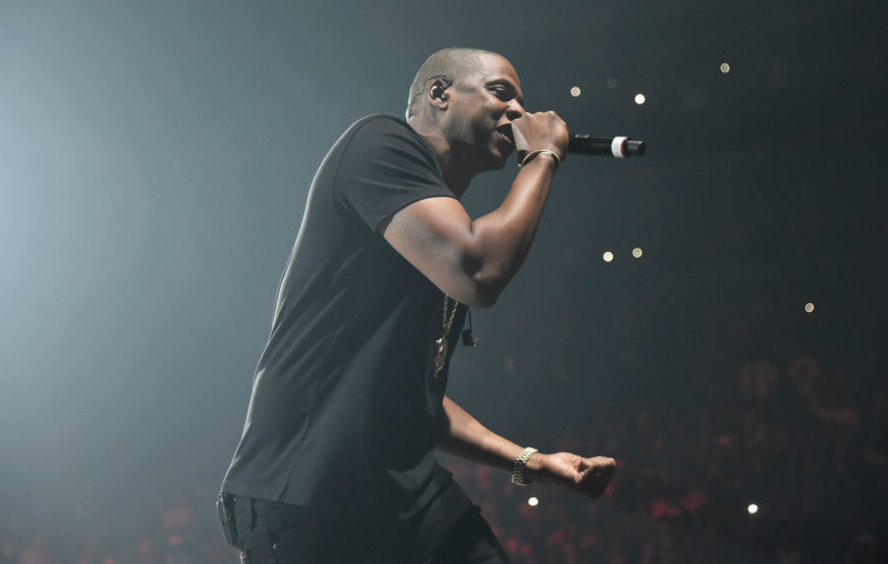 Jay-Z performing onstage with a microphone.