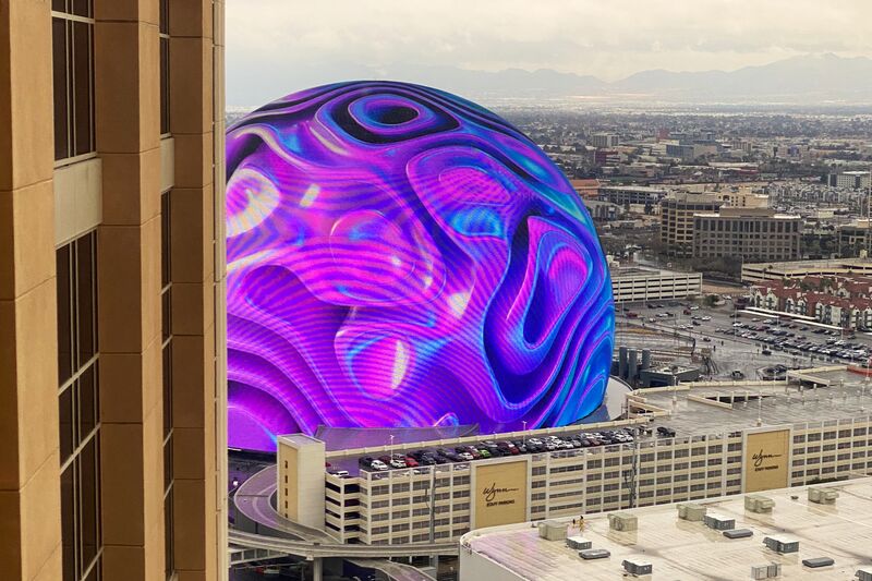 The Sphere in Las Vegas during the day with colorful swirling visuals on its exterior display