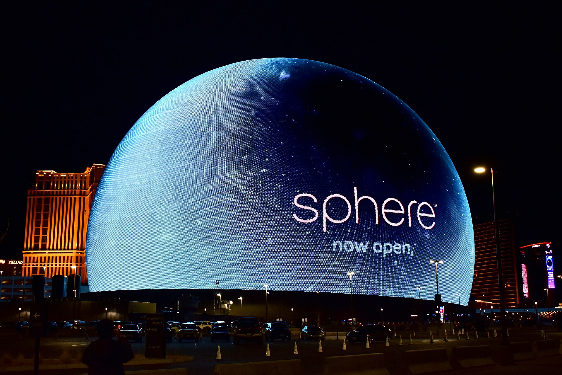 The Sphere's exosphere glowing blue at night during a U2 concert