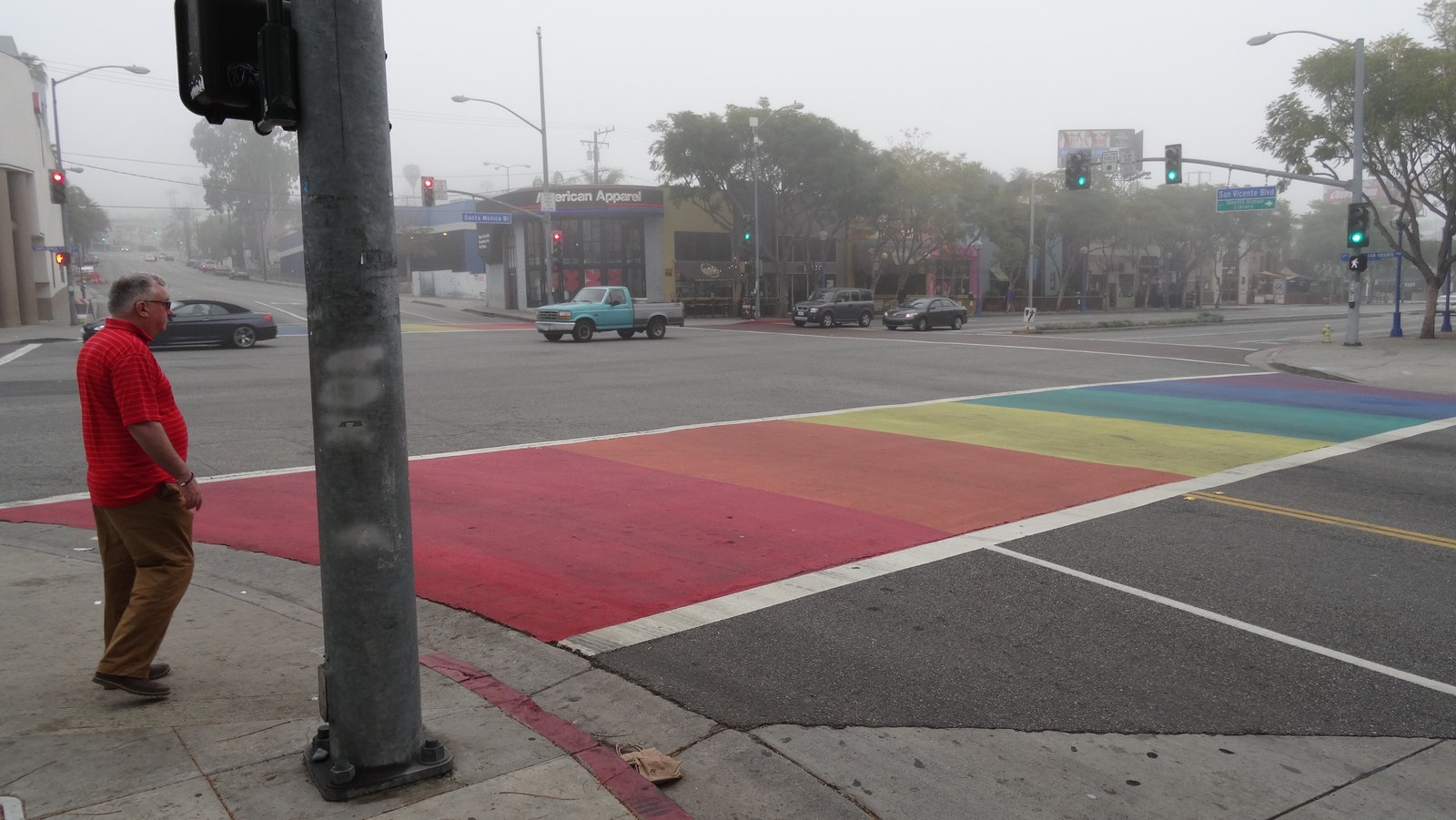 The rainbow crosswalk at San Vicente and Santa Monica boulevards in West Hollywood in bright daylight