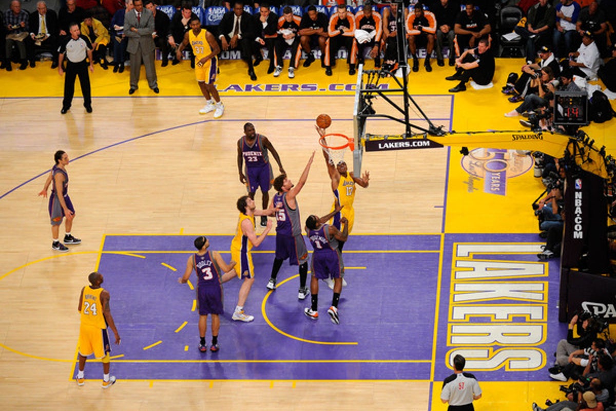 Lakers players contesting a shot under the basket during a game in Los Angeles