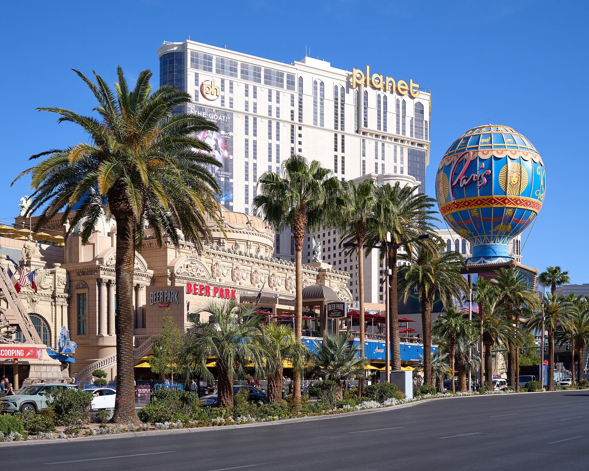 A daytime view of the Las Vegas Strip in 2026 — the sidewalk photo-hawker scene is an unregulated fixture of the boulevard.