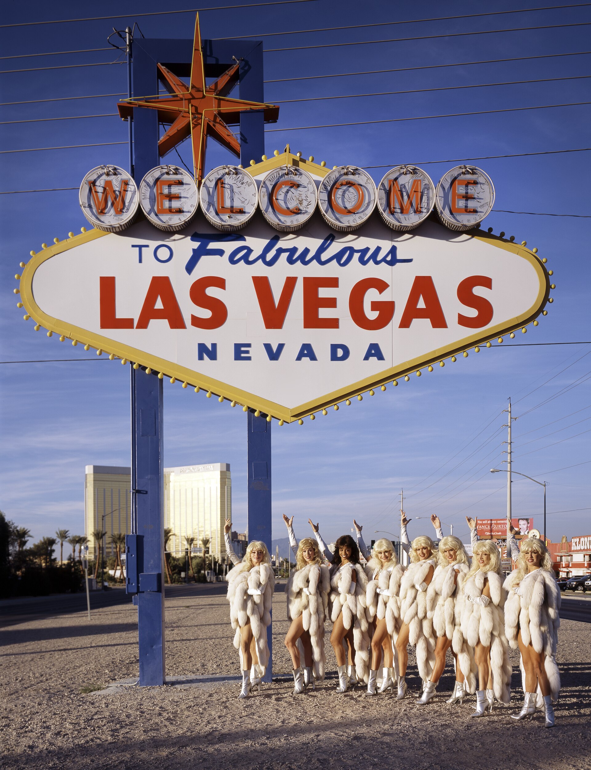 The Welcome to Fabulous Las Vegas sign with showgirls on a bright day