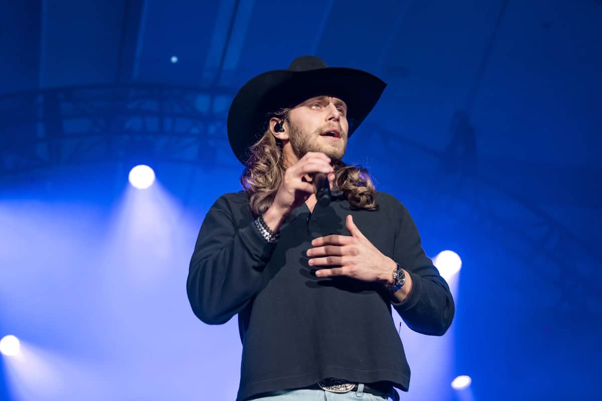 Warren Zeiders performing on stage in a cowboy hat