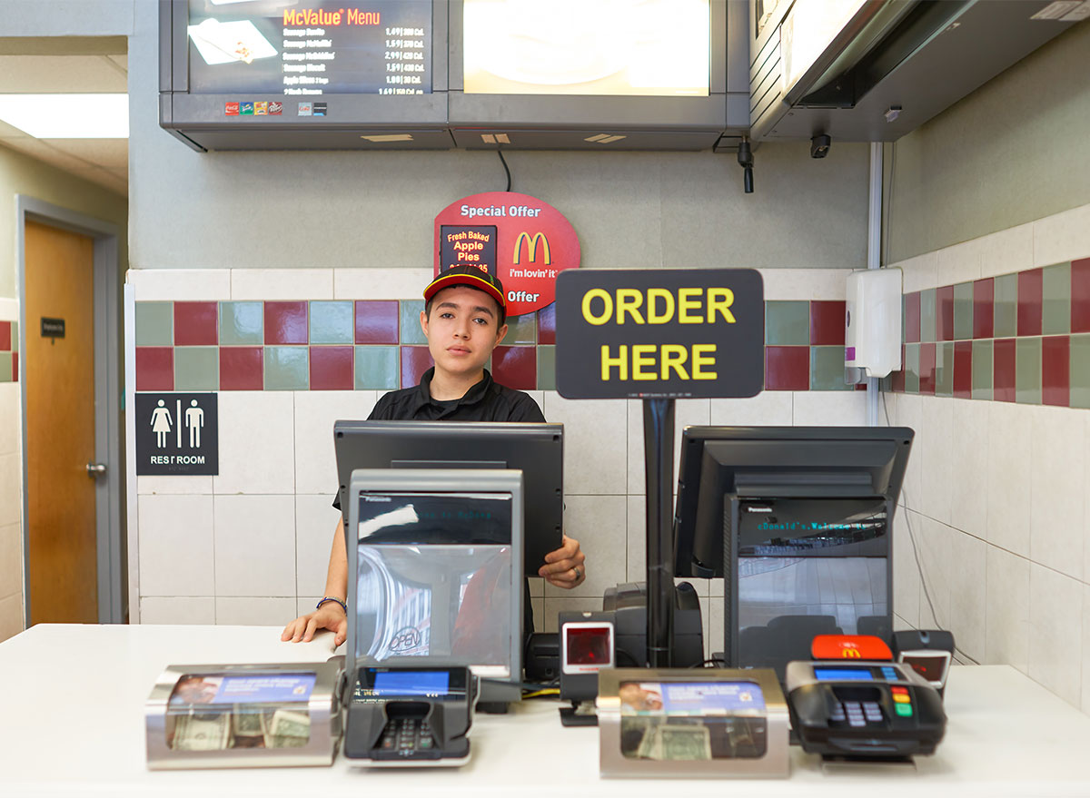 Customers ordering at a McDonald's restaurant counter.