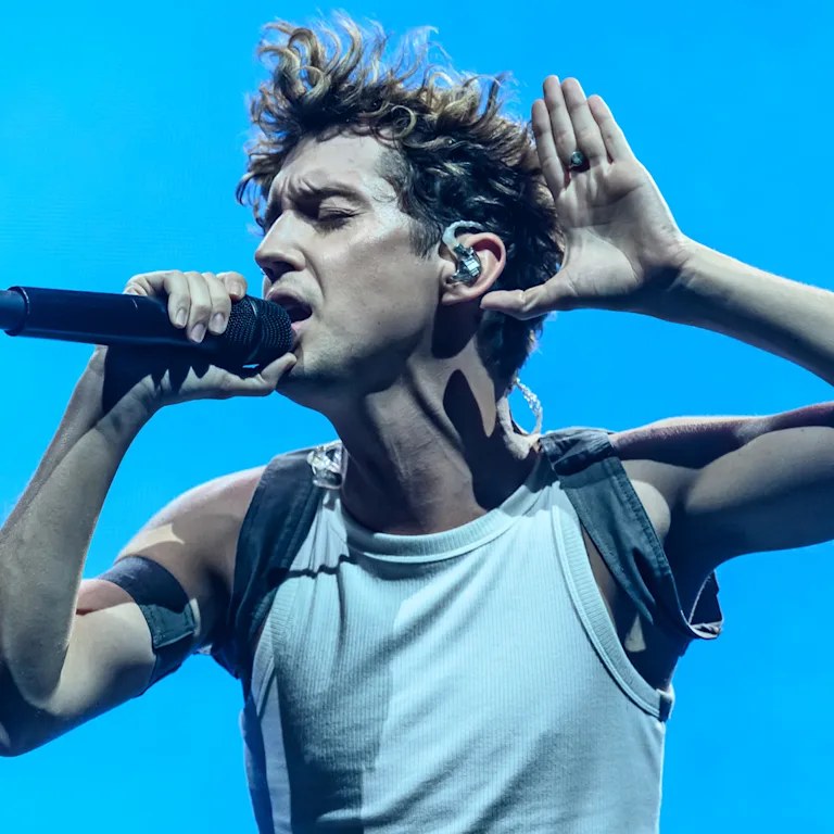 Troye Sivan performing on stage in vivid light — his album She’s the Best leads Friday’s stacked music drop day