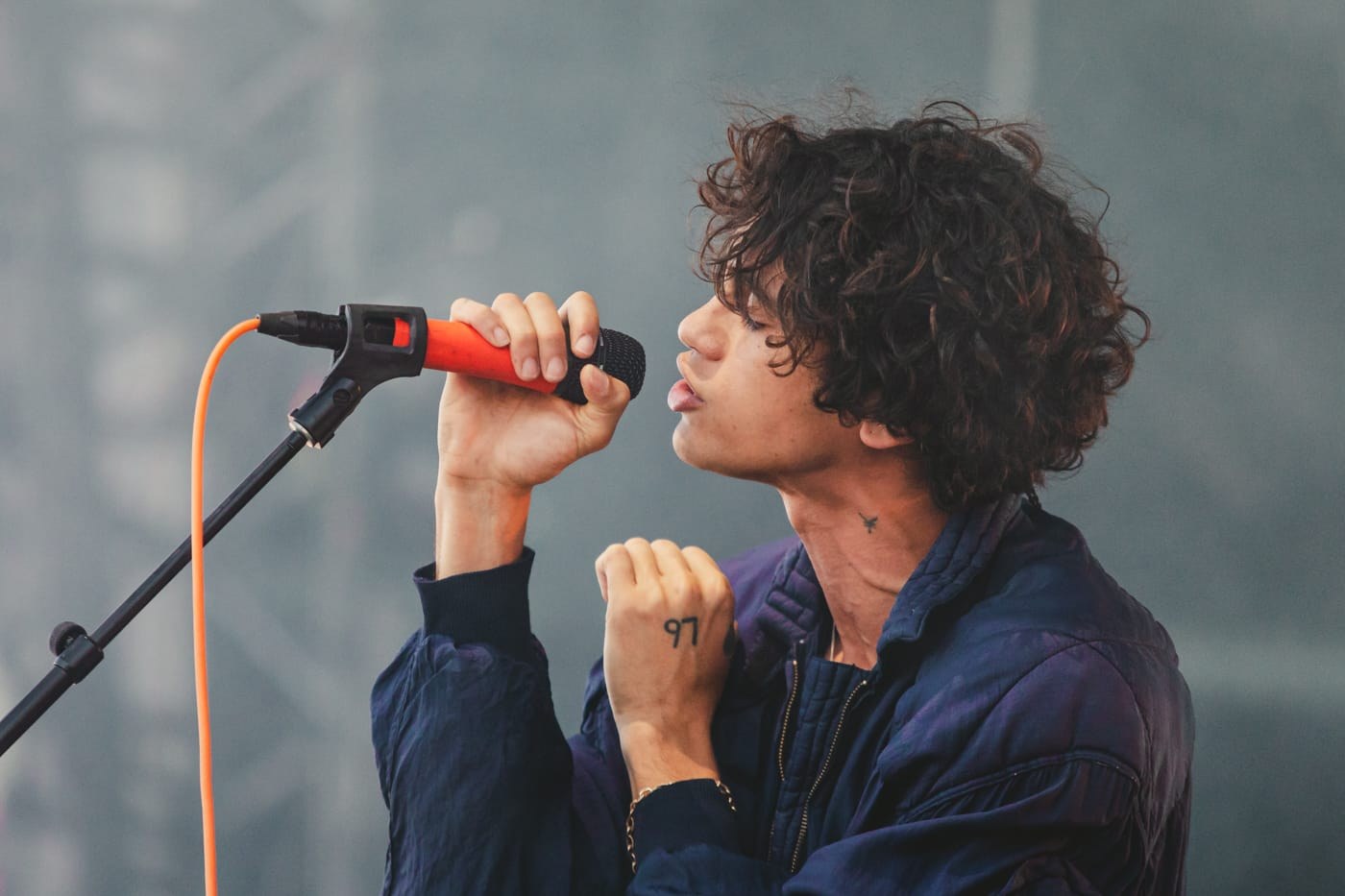 Dominic Fike performing at an outdoor festival