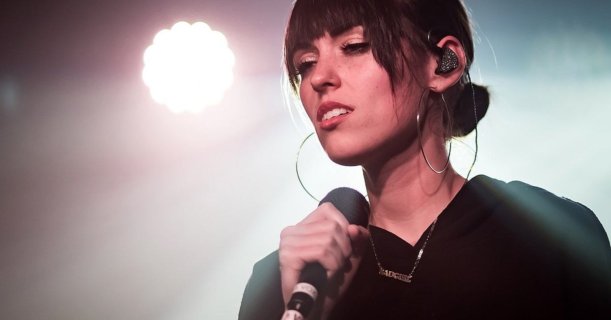 Sasha Alex Sloan performing live with a guitar