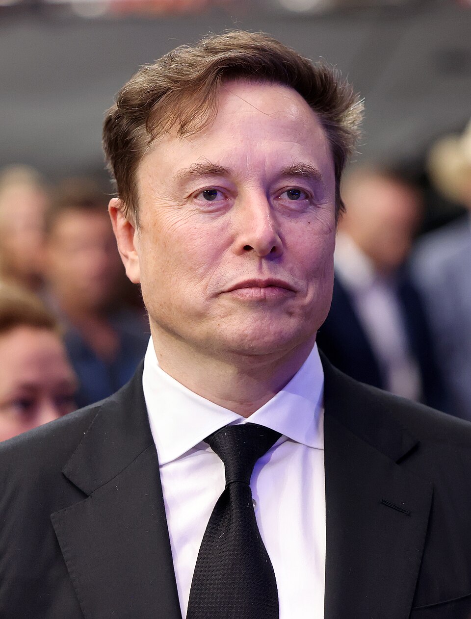 Elon Musk in a suit and tie at a formal event