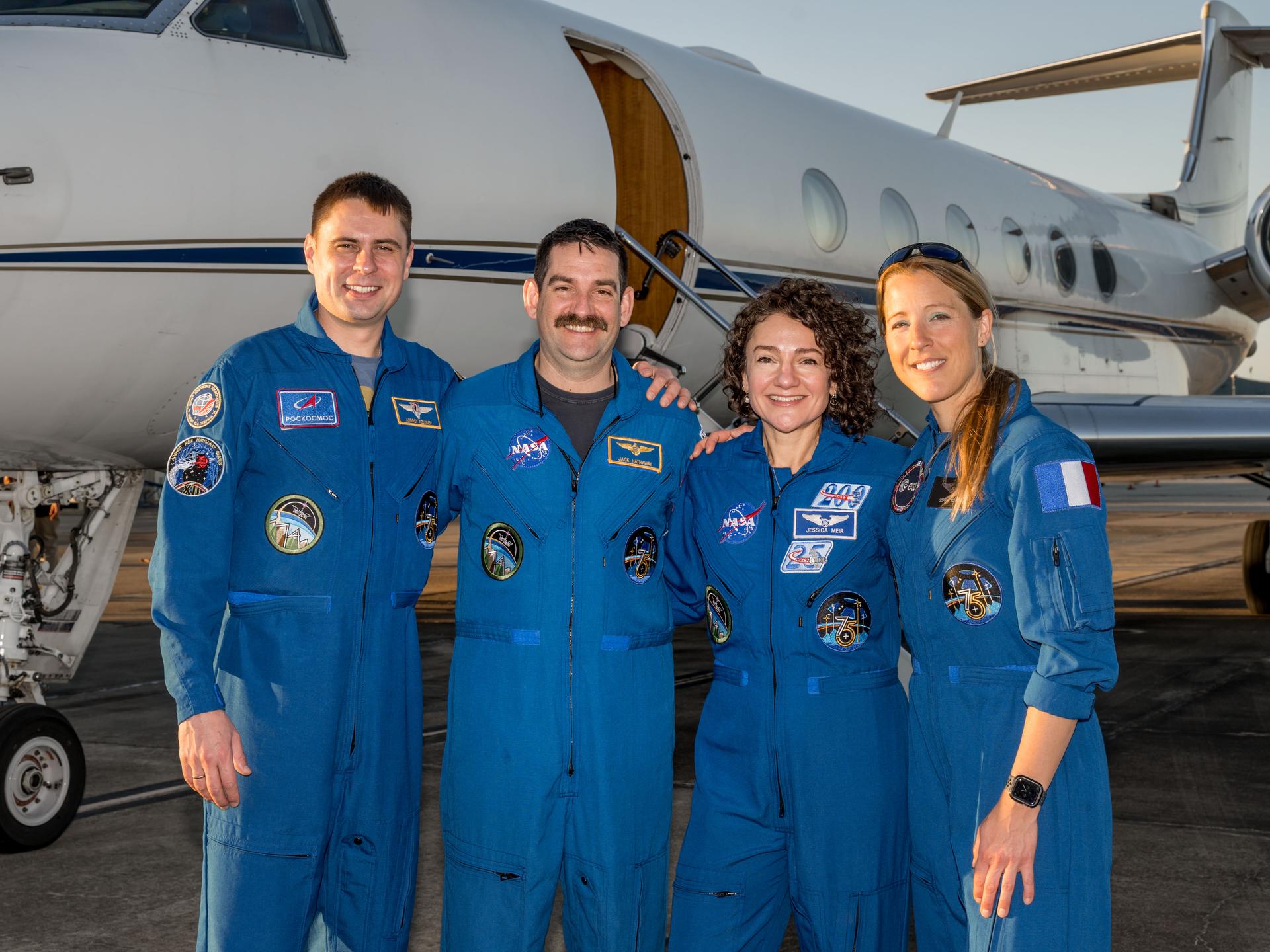 The four Crew-12 astronauts in flight suits