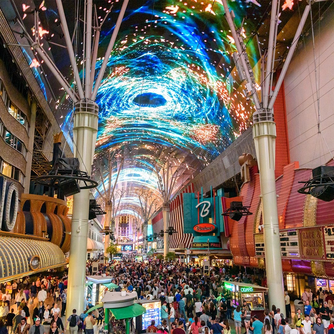The Fremont Street Experience canopy lit up over a crowd of visitors in downtown Las Vegas