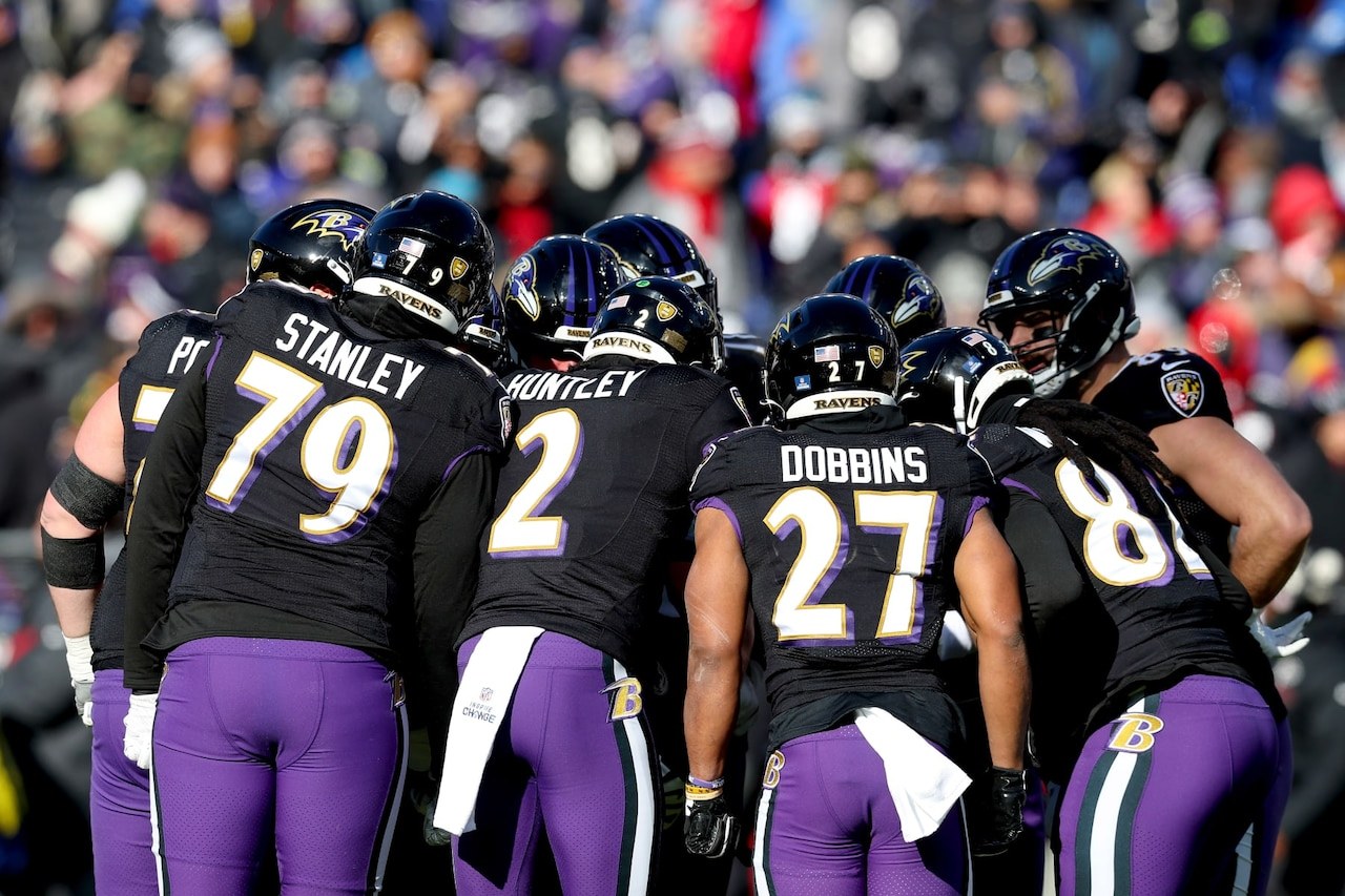 Baltimore Ravens players huddle during an NFL game (file photo)