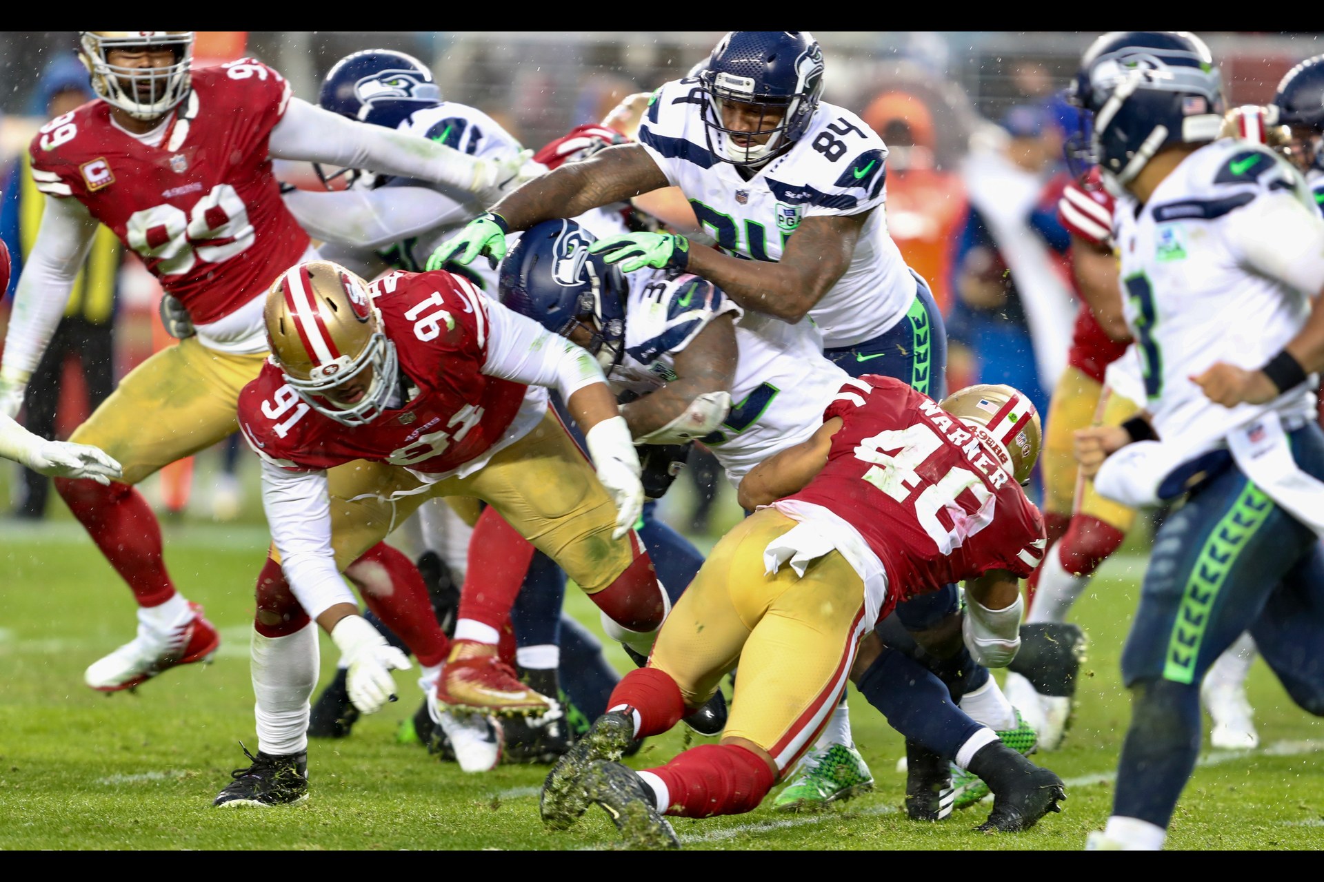 49ers and Seahawks players battle in the trenches during an NFL game