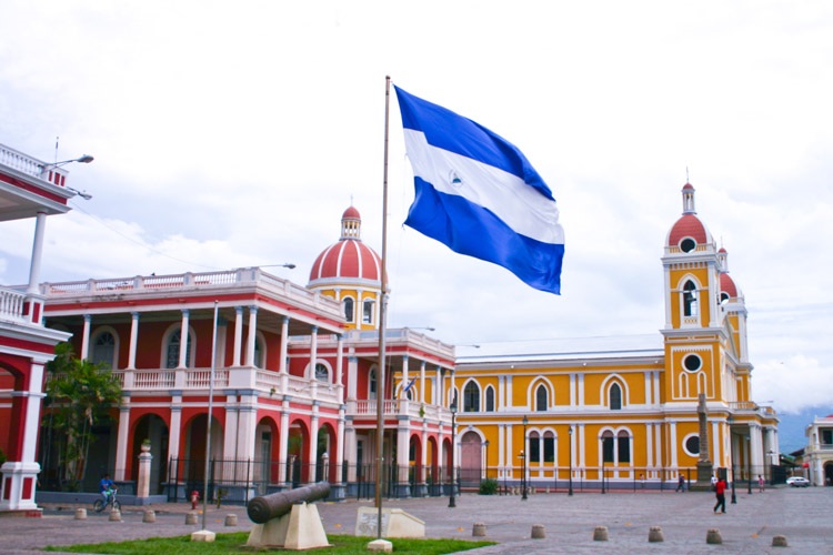The cathedral in Granada, Nicaragua, with the Nicaraguan flag flying in front
